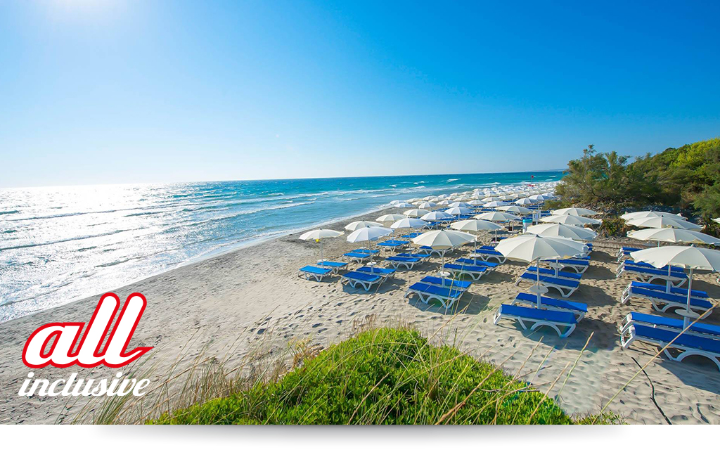 Spiaggia e Mare: "Spiaggia di sabbia bianca e mare cristallino del VOI Alimini Resort a Otranto, ideale per vacanze a metà settembre." Piscina: "Ampia piscina all'aperto circondata dal verde del giardino nel resort VOI Alimini in Puglia." Ristorazione: "Buffet vario e colorato nella sala ristorante del VOI Alimini Resort per gli ospiti in formula all-inclusive." Organizzazione Progetto Colombo Viaggi Bari